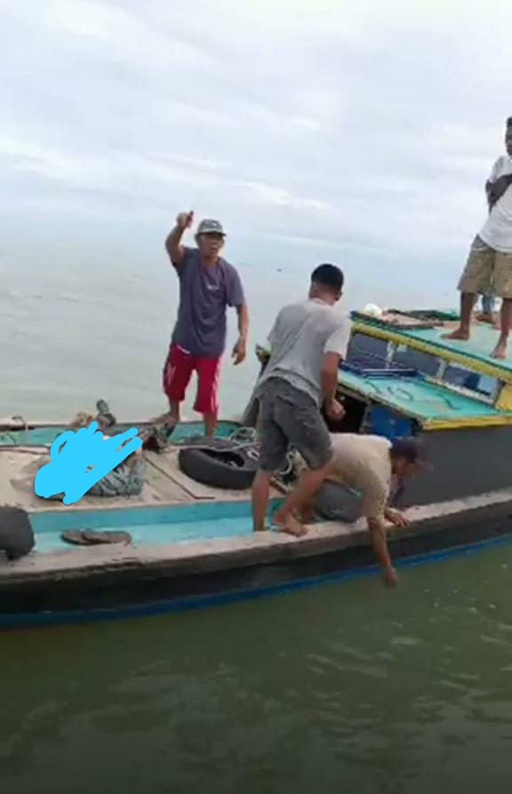 Nelayan setempat saat mengevakuasi jasad korban yang hilang diserang buaya.