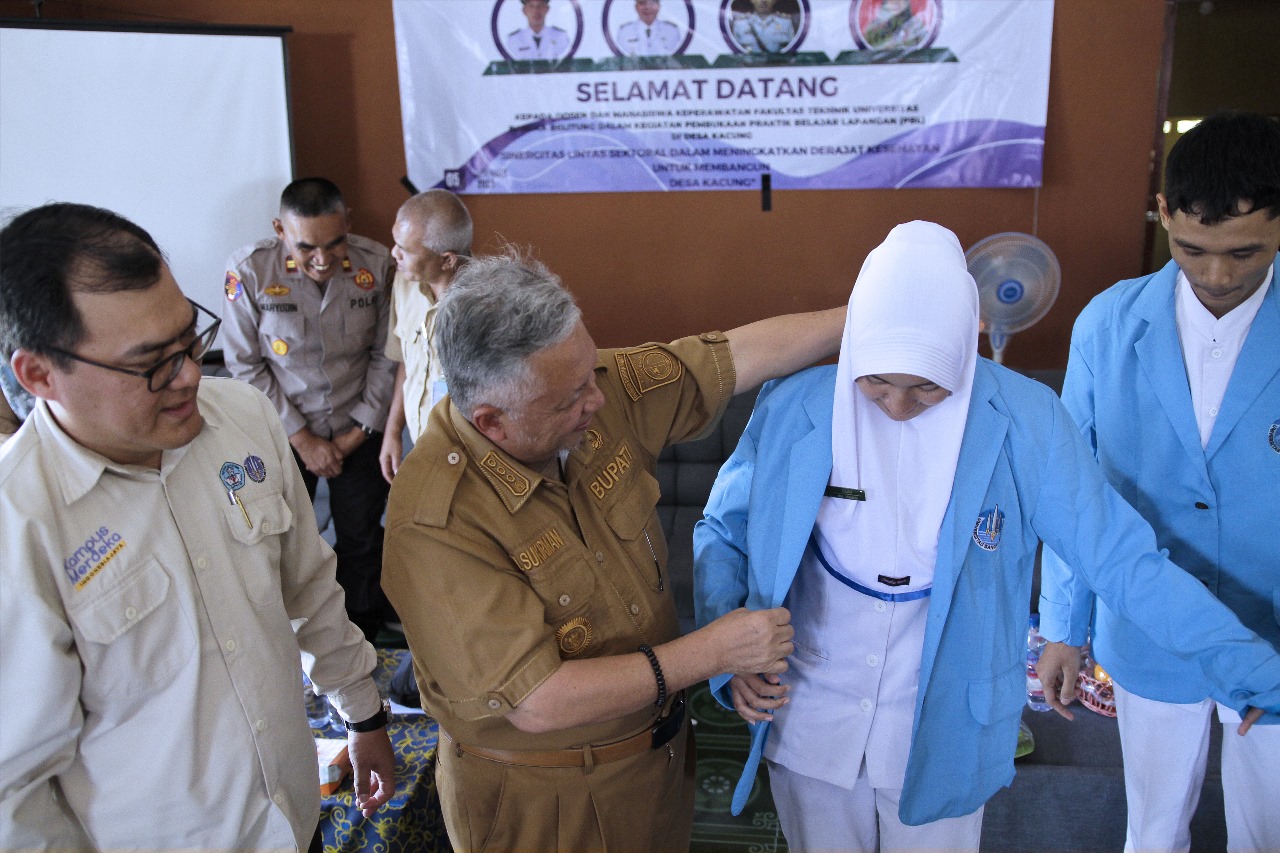 Caption: Bupati Bangka Barat Sukirman sematkan almamater ke mahasiswa UBB Keperawatan yang melaksanakan Praktik Belajar Lapangan (PBL) di Desa Kacung, Kelapa, Selasa (5/12/2023). (Diskominfo Babar).